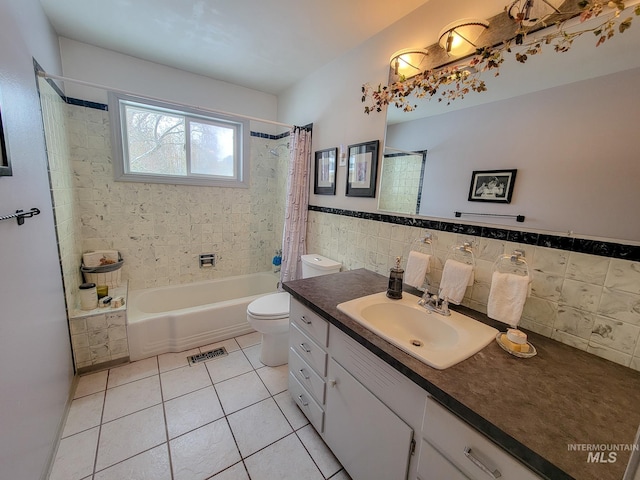 bathroom featuring shower / tub combo, visible vents, toilet, tile patterned flooring, and tile walls