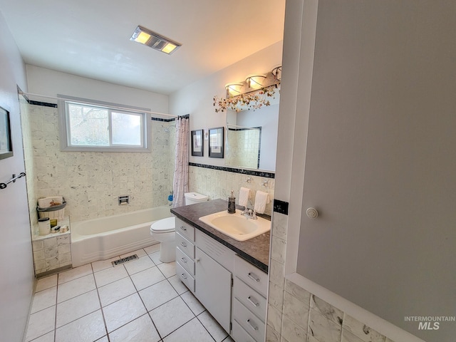 full bath featuring visible vents, toilet, tile patterned flooring, vanity, and tile walls