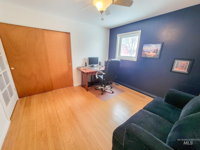 home office with a ceiling fan and wood finished floors