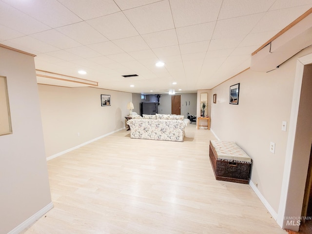 living area with light wood-style floors, recessed lighting, visible vents, and baseboards