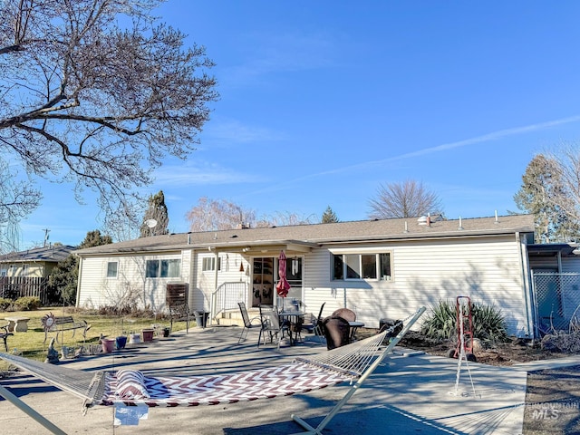 rear view of property with a patio area and fence