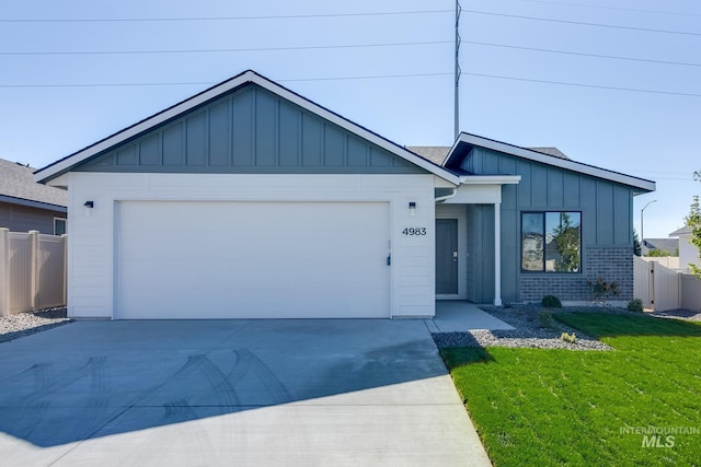 view of front of home with a garage and a front lawn