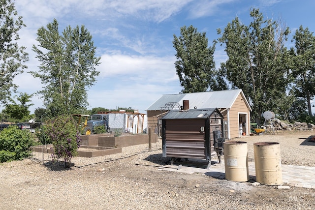 10489 Scotch Pine Rd, Payette, ID 83661 - view of front facade with a garden, an outbuilding, and a metal roof