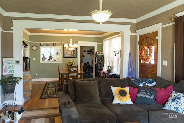10489 Scotch Pine Rd, Payette, ID 83661 - living area with a chandelier, wood finished floors, ornamental molding, and ornate columns