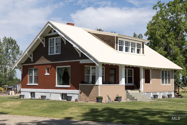 10489 Scotch Pine Rd, Payette, ID 83661 - view of front facade with a porch, a chimney, and a front lawn