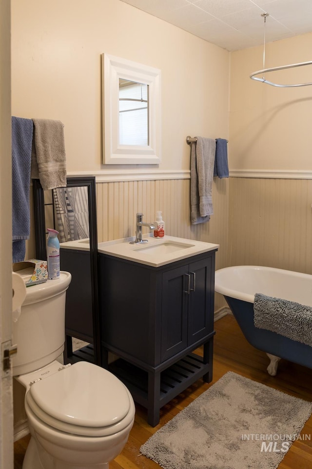 10489 Scotch Pine Rd, Payette, ID 83661 - bathroom featuring a wainscoted wall, a freestanding bath, wood finished floors, and vanity