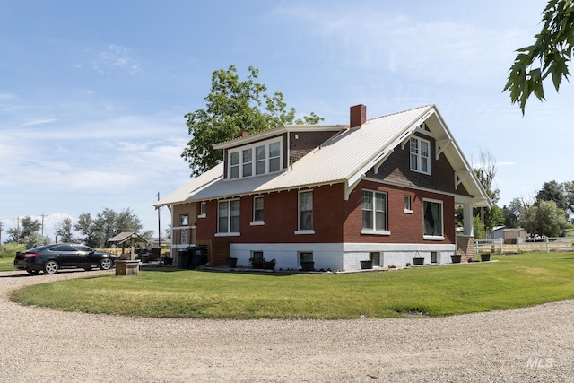 10489 Scotch Pine Rd, Payette, ID 83661 - view of home's exterior with a chimney, a lawn, and a metal roof