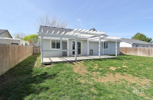 rear view of property featuring a lawn, a pergola, a fenced backyard, and a wooden deck