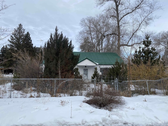 yard layered in snow featuring a fenced front yard