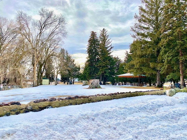 snowy yard with a gazebo