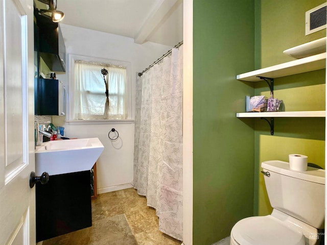 bathroom featuring visible vents, vanity, toilet, and baseboards