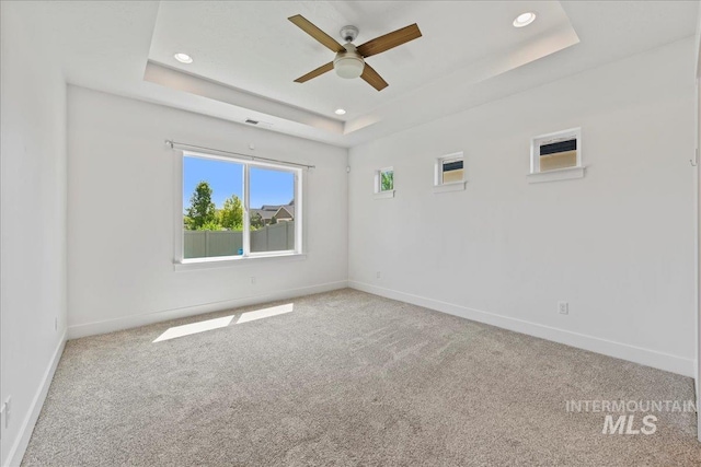 2967 E Diorite St, Nampa, ID 83686 - carpeted spare room featuring a ceiling fan, a tray ceiling, baseboards, and recessed lighting