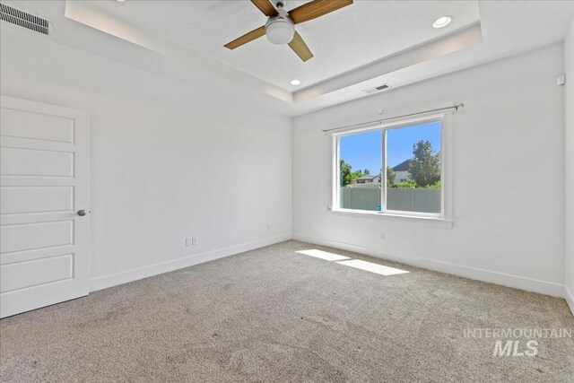 2967 E Diorite St, Nampa, ID 83686 - carpeted spare room with a tray ceiling, a ceiling fan, baseboards, and recessed lighting