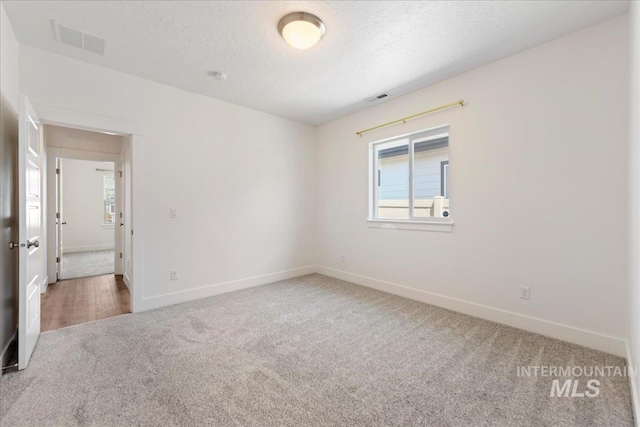 2967 E Diorite St, Nampa, ID 83686 - carpeted empty room featuring baseboards and a textured ceiling
