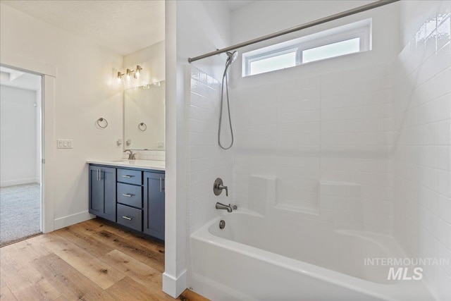 2967 E Diorite St, Nampa, ID 83686 - bathroom with vanity, wood finished floors, shower / washtub combination, and baseboards