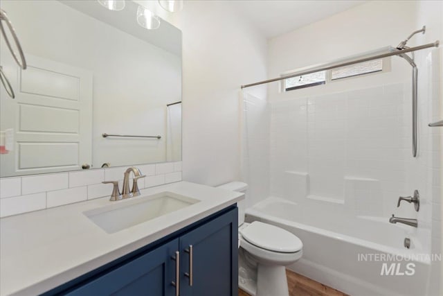 2967 E Diorite St, Nampa, ID 83686 - bathroom with vanity, toilet,  shower combination, backsplash, and wood finished floors
