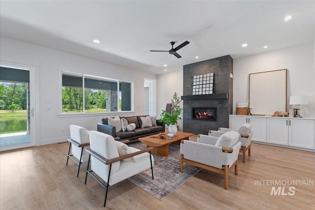 124 S Eagles Roost Way, Eagle, ID 83616 - living room featuring light wood finished floors, ceiling fan, a tile fireplace, and recessed lighting