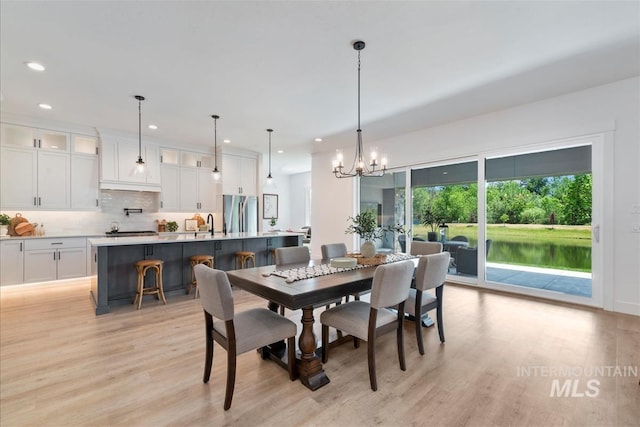 124 S Eagles Roost Way, Eagle, ID 83616 - dining room featuring light wood-style flooring, a chandelier, and recessed lighting