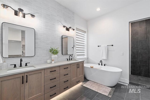 124 S Eagles Roost Way, Eagle, ID 83616 - full bath with a freestanding bath, double vanity, backsplash, tile patterned floors, and a tile shower