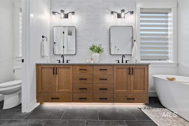 124 S Eagles Roost Way, Eagle, ID 83616 - full bathroom with double vanity, a freestanding bath, healthy amount of natural light, and tasteful backsplash