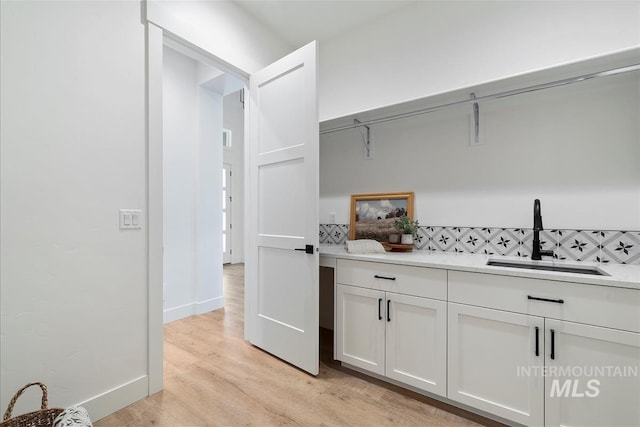 124 S Eagles Roost Way, Eagle, ID 83616 - laundry area with a sink and light wood-style flooring