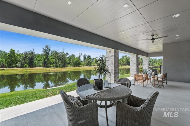 124 S Eagles Roost Way, Eagle, ID 83616 - view of patio featuring a water view, ceiling fan, outdoor dining space, and view of scattered trees