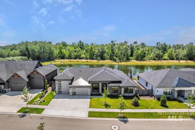 124 S Eagles Roost Way, Eagle, ID 83616 - view of front facade with concrete driveway, a garage, and a water view