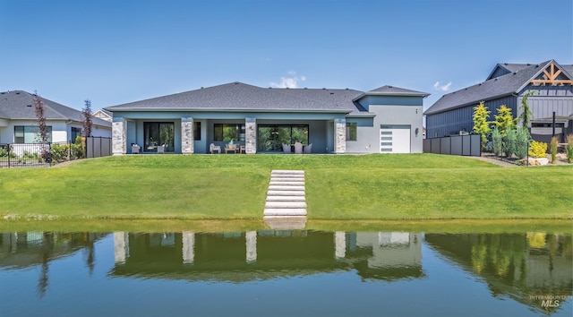 124 S Eagles Roost Way, Eagle, ID 83616 - rear view of house with a water view, stucco siding, roof with shingles, and a garage