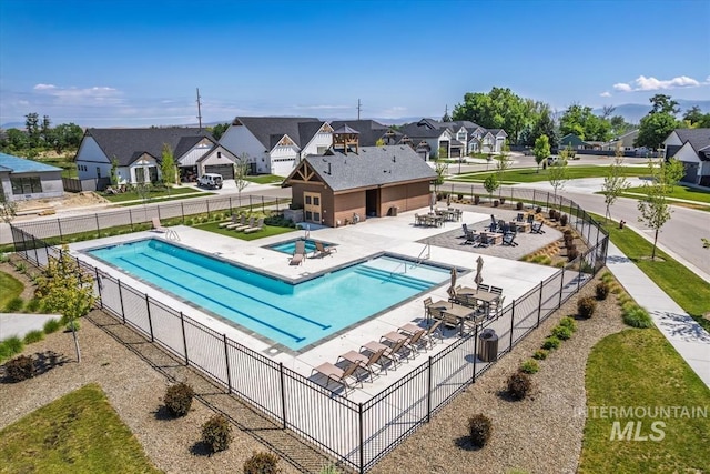 124 S Eagles Roost Way, Eagle, ID 83616 - community pool featuring a residential view, a hot tub, and a patio area