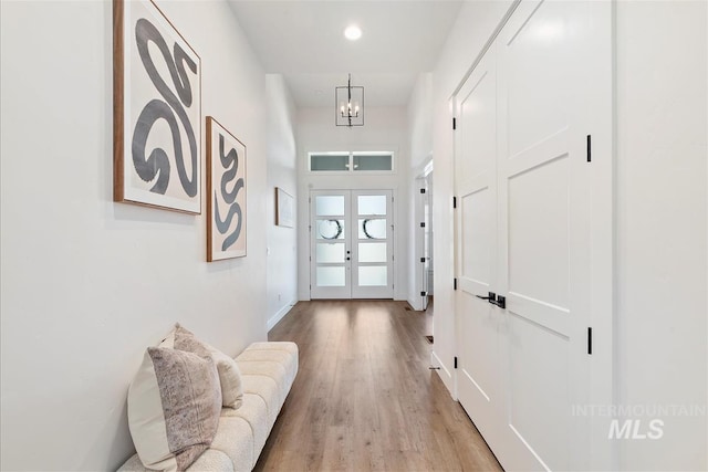 124 S Eagles Roost Way, Eagle, ID 83616 - hall featuring light wood-style floors, a chandelier, and recessed lighting