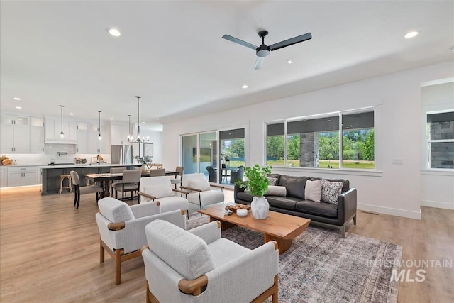 124 S Eagles Roost Way, Eagle, ID 83616 - living room with light wood-style floors, recessed lighting, and a ceiling fan