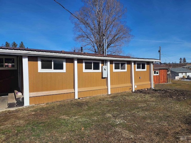 view of side of home featuring a lawn