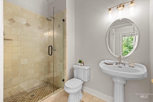 full bath featuring a stall shower, tile patterned floors, toilet, and baseboards