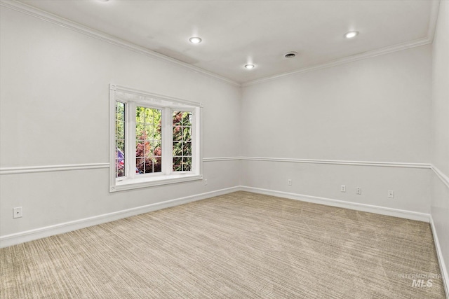 carpeted spare room with crown molding, baseboards, and recessed lighting