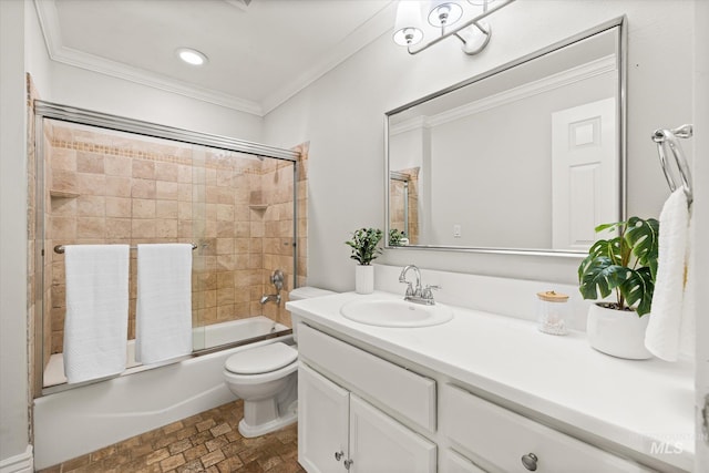 full bath with ornamental molding, vanity, toilet, combined bath / shower with glass door, and brick patterned floors