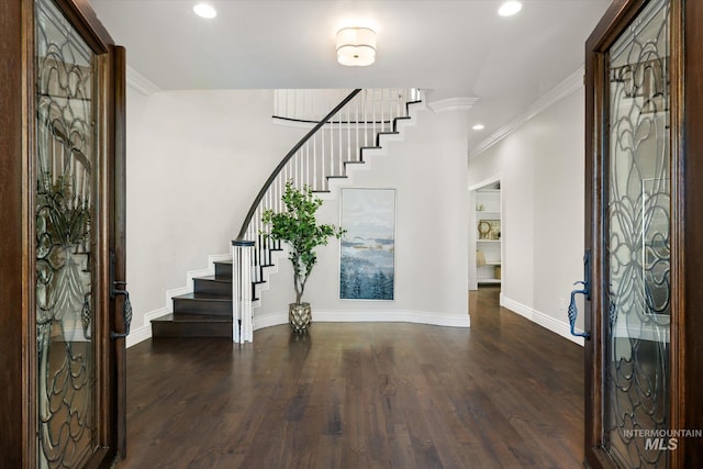 foyer entrance featuring stairway, crown molding, baseboards, dark wood-type flooring, and recessed lighting
