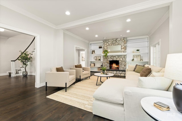 living room featuring wood finished floors, stairway, baseboards, recessed lighting, and a fireplace