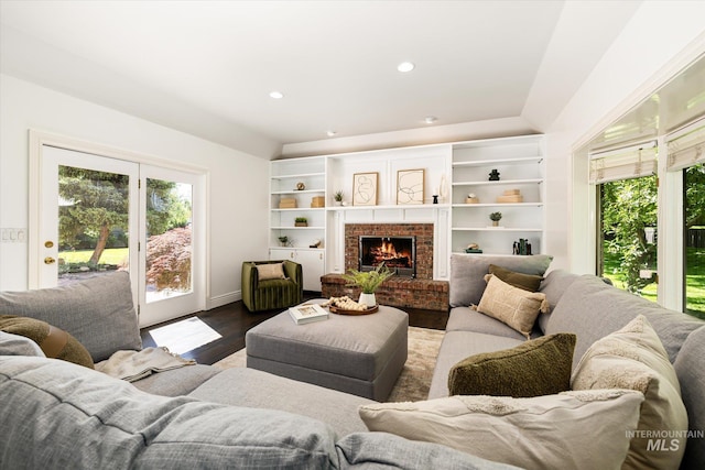 living area featuring dark wood-style floors and a fireplace