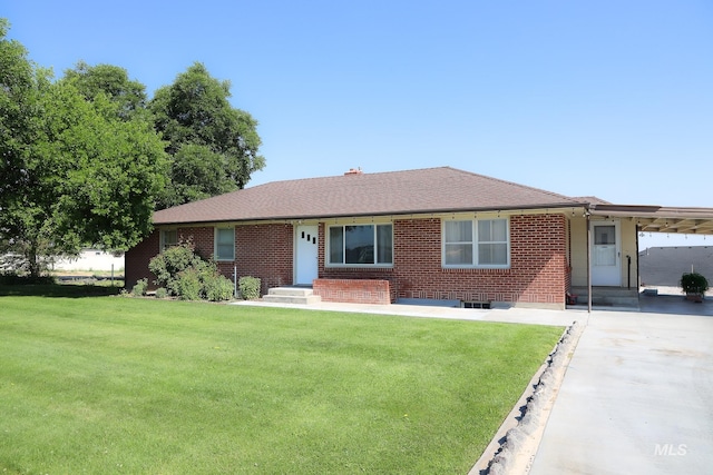 ranch-style home featuring a carport and a front yard