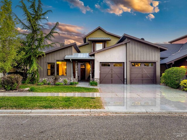 1337 E Lone Shore Dr, Eagle, ID 83616 - view of front of property featuring an attached garage, driveway, a standing seam roof, metal roof, and stone siding