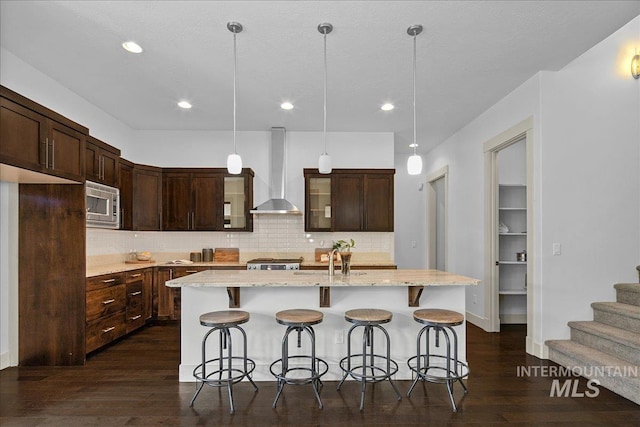 1337 E Lone Shore Dr, Eagle, ID 83616 - kitchen with wall chimney exhaust hood, stainless steel microwave, dark wood-style floors, decorative backsplash, and a sink