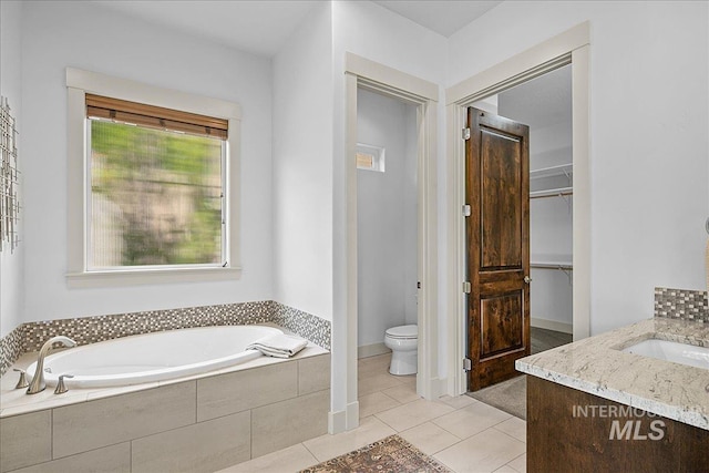 1337 E Lone Shore Dr, Eagle, ID 83616 - bathroom with toilet, a bath, tile patterned flooring, a spacious closet, and vanity