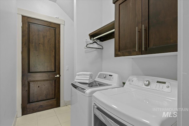 1337 E Lone Shore Dr, Eagle, ID 83616 - washroom featuring cabinet space, washing machine and clothes dryer, light tile patterned floors, and baseboards