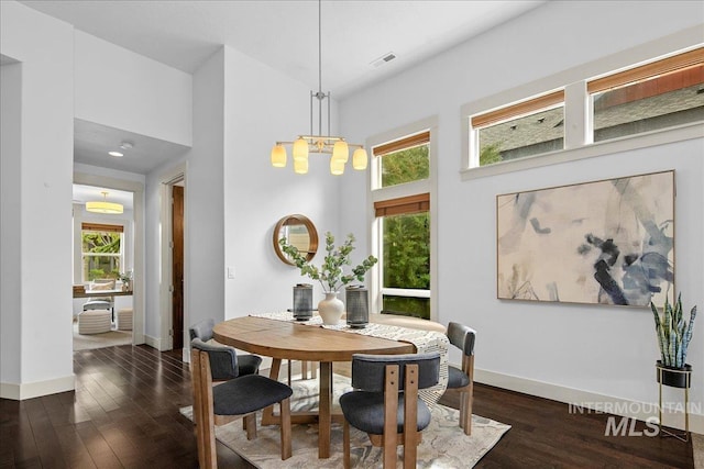 1337 E Lone Shore Dr, Eagle, ID 83616 - dining room with a towering ceiling, baseboards, dark wood-type flooring, and a chandelier