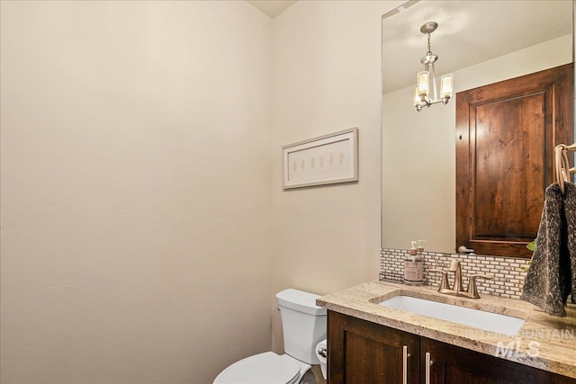 1337 E Lone Shore Dr, Eagle, ID 83616 - bathroom with tasteful backsplash, toilet, vanity, and a chandelier