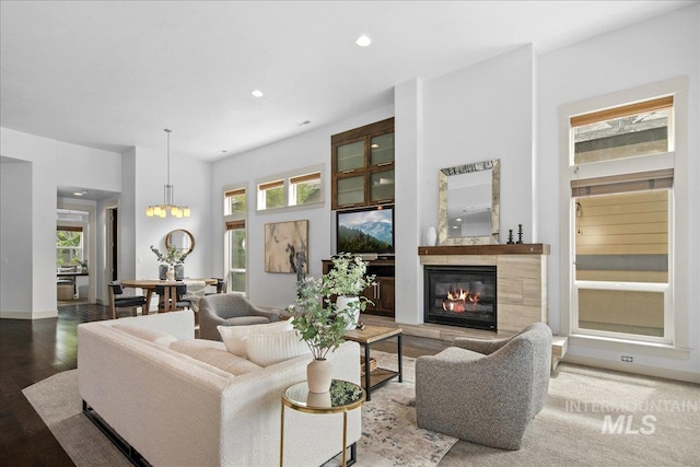 1337 E Lone Shore Dr, Eagle, ID 83616 - living room with plenty of natural light, a high end fireplace, wood finished floors, recessed lighting, and a chandelier