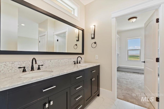 bathroom with double vanity, a wealth of natural light, and a sink