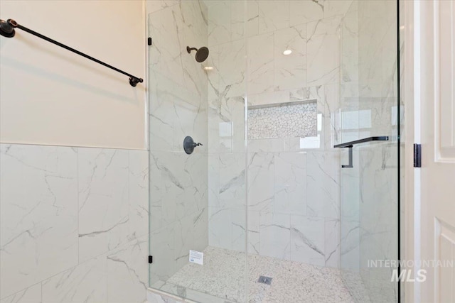 full bathroom with a marble finish shower