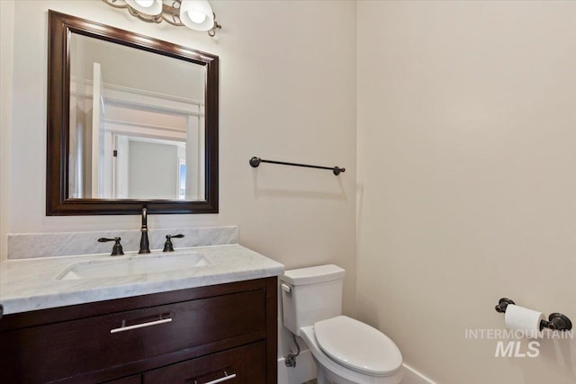 bathroom with toilet and vanity