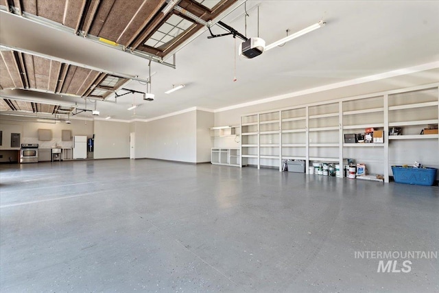 garage featuring electric panel, baseboards, and a garage door opener